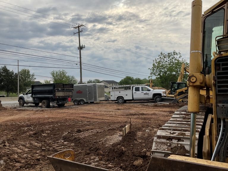 DESCCO trucks and construction equipment at a work site