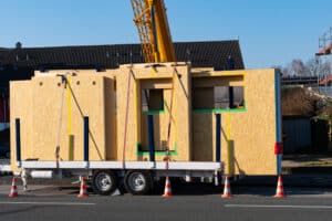 Image of constructed building walls strapped on a trailer.